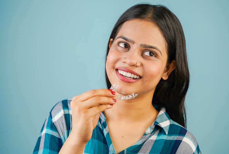 Dentist fitting clear aligners for invisible teeth straightening treatment